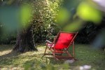 A red deckchair primed for its lazy occupant